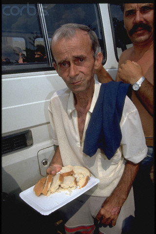 Bosnian Genocide, 1992: Emaciated non-Serb civilians during a staged lunch, posing for TV cameras, at the Serb-run Trnopolje concentration camp near Prijedor in 1992. Thousands of prisoners, mostly Bosniaks (Bosnian Muslims), were tortured and killed there in 1992. Photographer: Patrick Robert